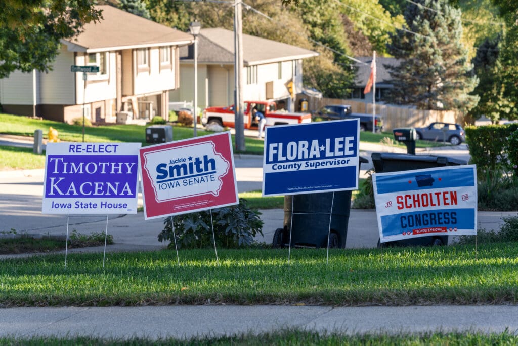 Political campaign signs in a Sioux City, Iowa neighborhood ahead of the 2018 midterm elections. FLORA LEE County Supervisor TIMOTHY KACENA lowa State House Jackie Smith IOWA SENATE JD SCHOLTEN CONGRESS SCHOLTEN4IOWA